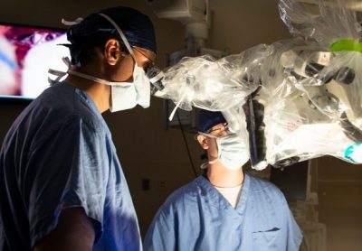 Drs. Ketan Bulsara and Daniel Roberts use the new Augmented Reality Microscope in the Hybrid OR at UConn John Dempsey Hospital