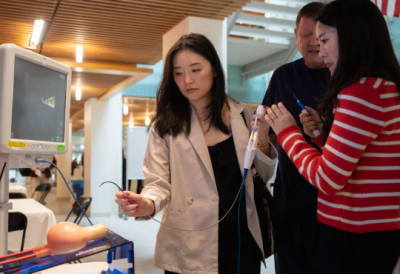 Three students in urology surgical simulation training together at last Symposium held at Brown University.